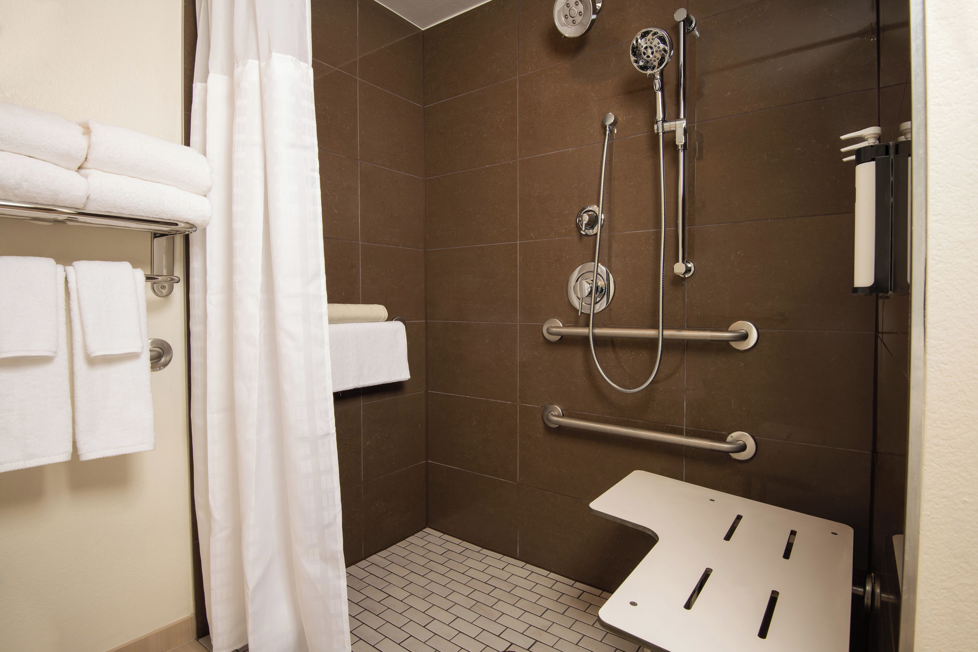 designer toiletries, hair dryer, towels