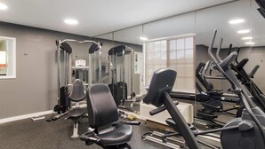 A gym with exercise equipment, a mirror, and a window. - MainStay Suites Denver Tech Center (Centennial)