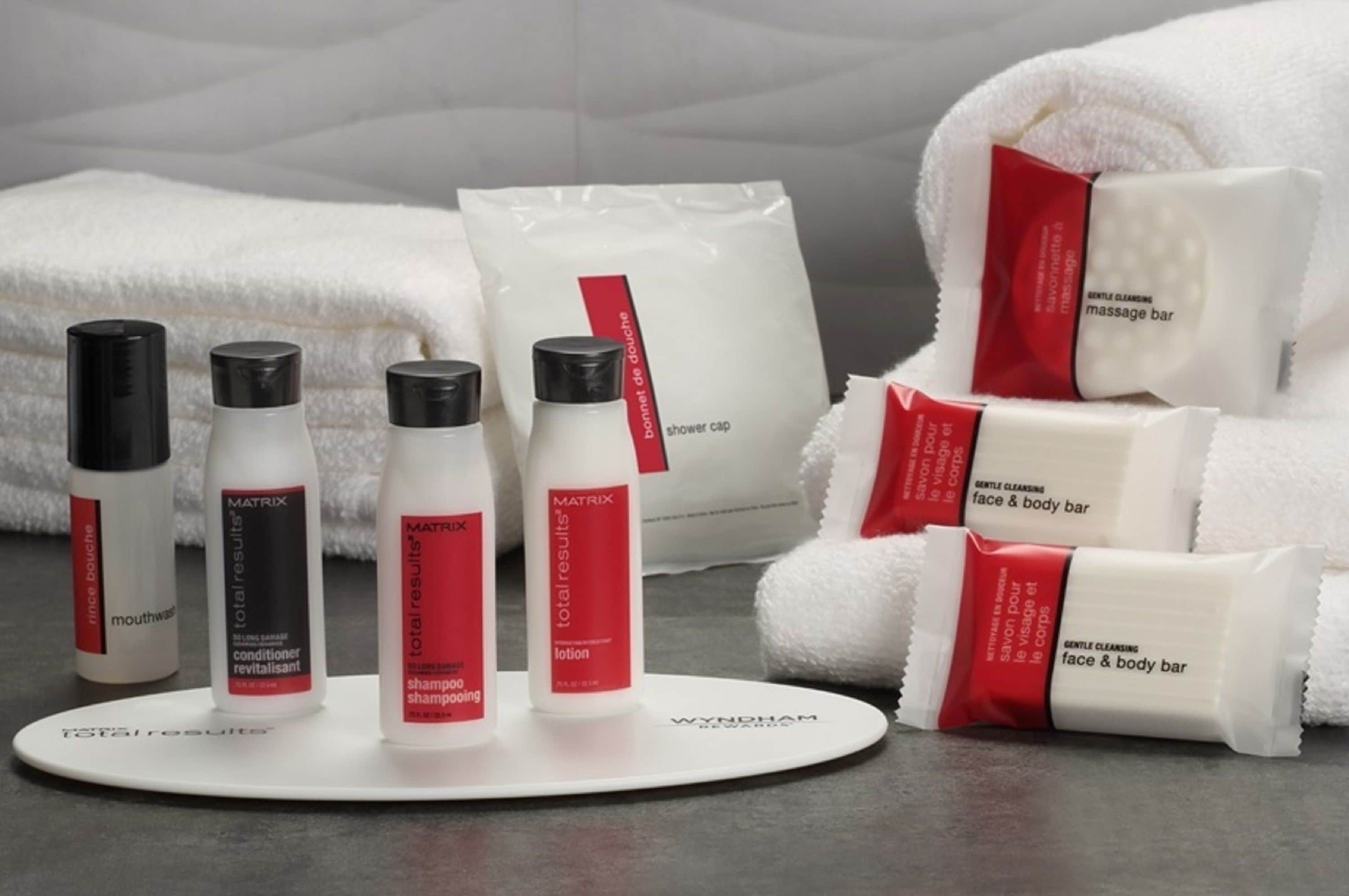 A display of skincare products including a shower cap, lotion, and a face and body bar.