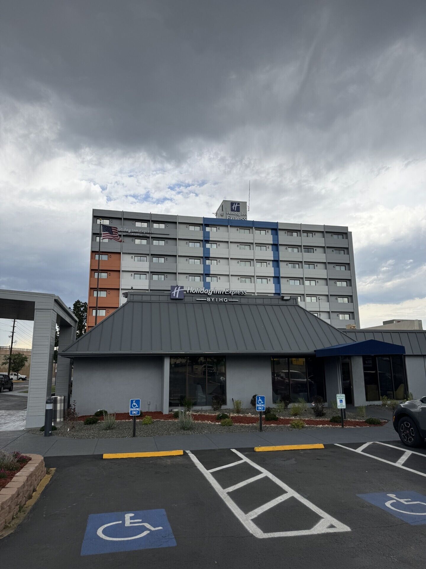 A Holiday Inn Express hotel with a modern design, including a parking lot with handicapped parking spaces.