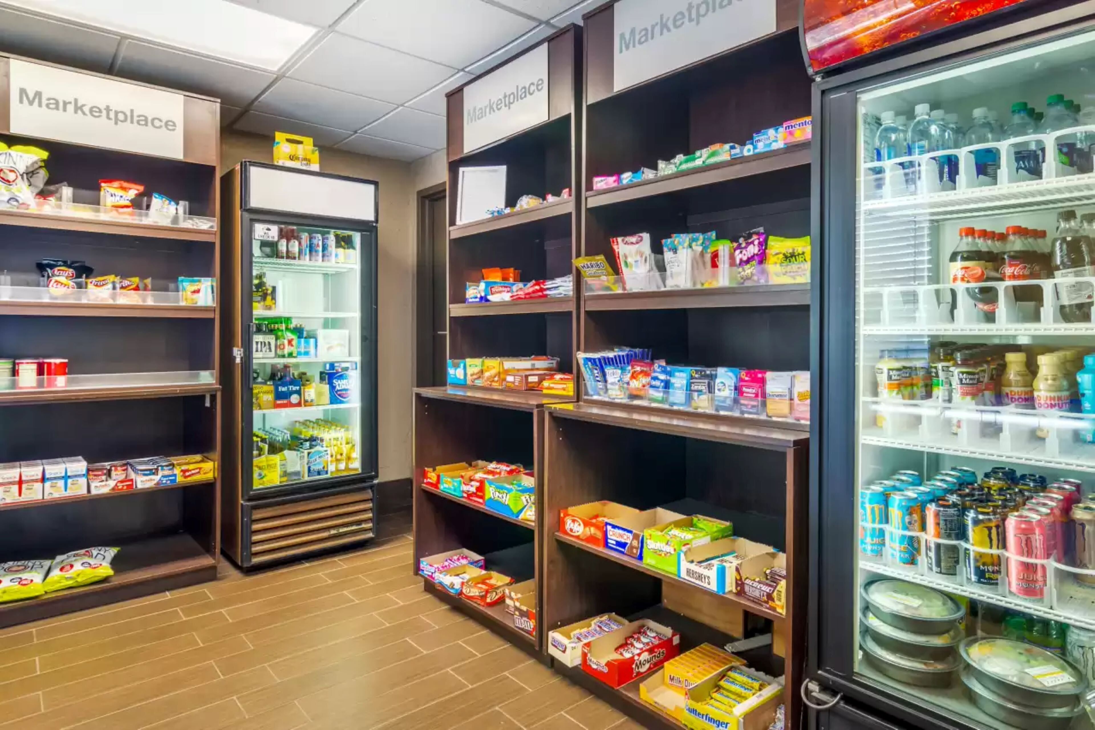 A grocery store with shelves stocked with snacks, beverages, and dairy products.