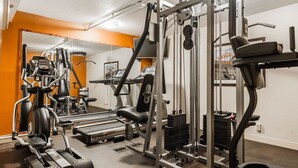 A gym with cardio machines, weightlifting equipment, and a mirrored wall. - Spark by Hilton Denver East I 70 (Denver)