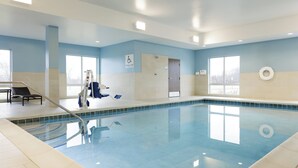 An indoor swimming pool with a lifeguard chair, a pool lift, and a wheelchair-accessible door. - Holiday Inn Express - Layton by IHG (Layton)