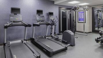 A gym with treadmills, a stationary bike, and weight machines.