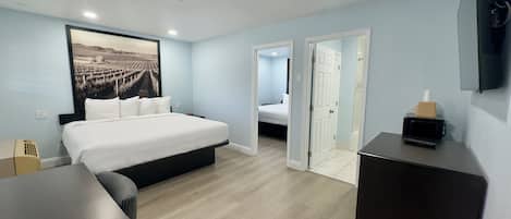 Suite, 2 chambres | Bureau, systĂšme dâinsonorisation, fer et planche Ă repasser