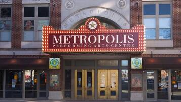 The exterior of the Metropolis Performing Arts Centre with a marquee sign, entrance doors, and a brick facade.