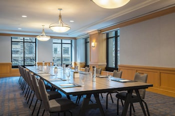Conference room with a long table, high ceiling, and large window offering a view of the outside. at The Westin Chicago River North