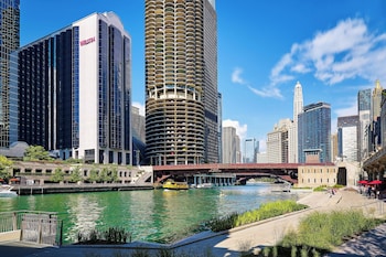 Experience the vibrant cityscape with stunning views of the river and a pedestrian bridge connecting the area. at The Westin Chicago River North