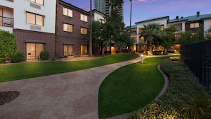 A residential area with modern buildings, a well-maintained lawn, and a curved pathway. - Sonesta Select Tempe Downtown (Tempe)