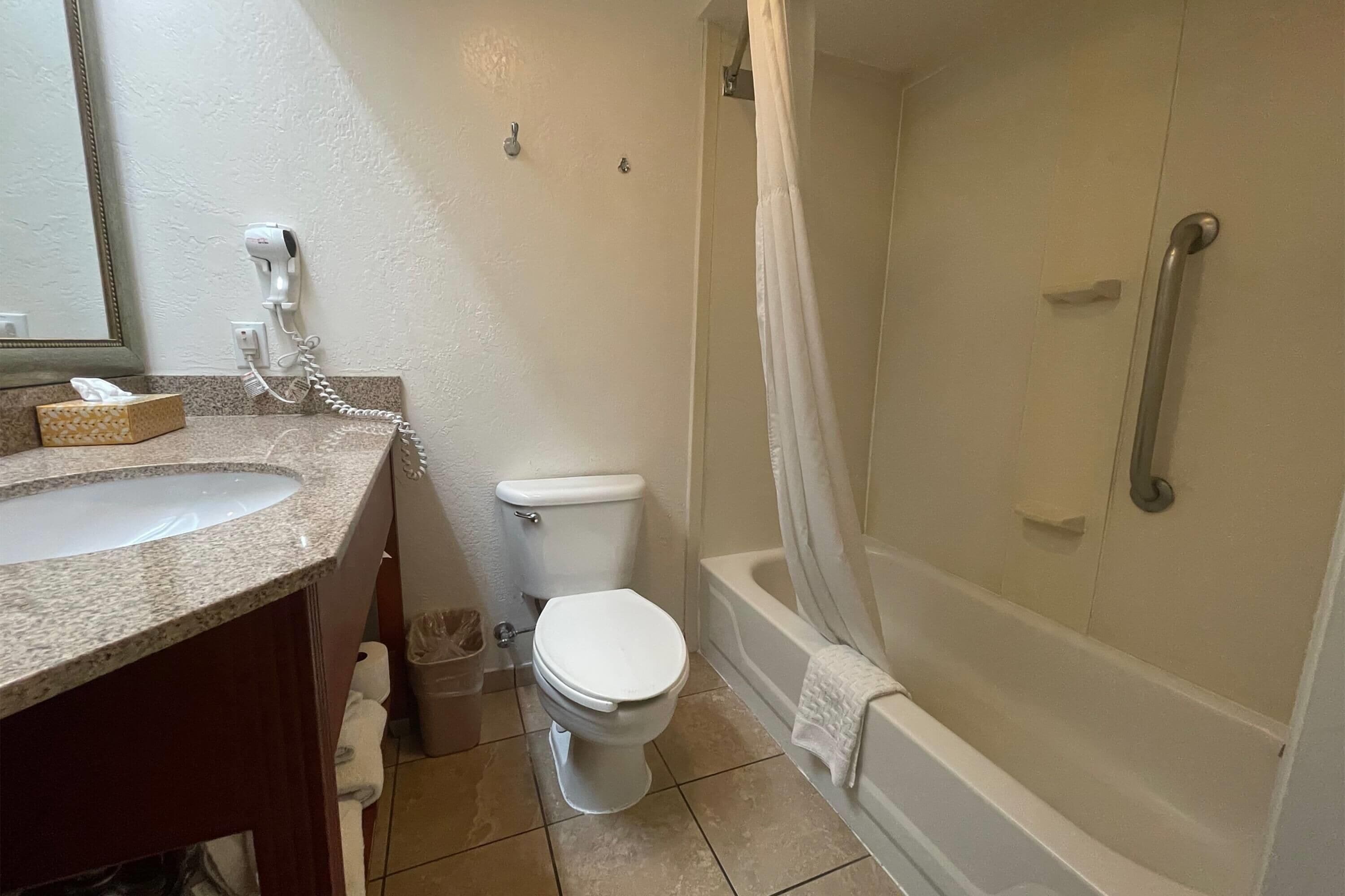 A bathroom with a sink, toilet, and shower.