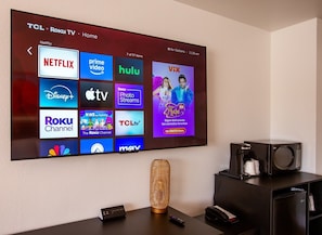 A TCL Roku TV displaying various streaming services.