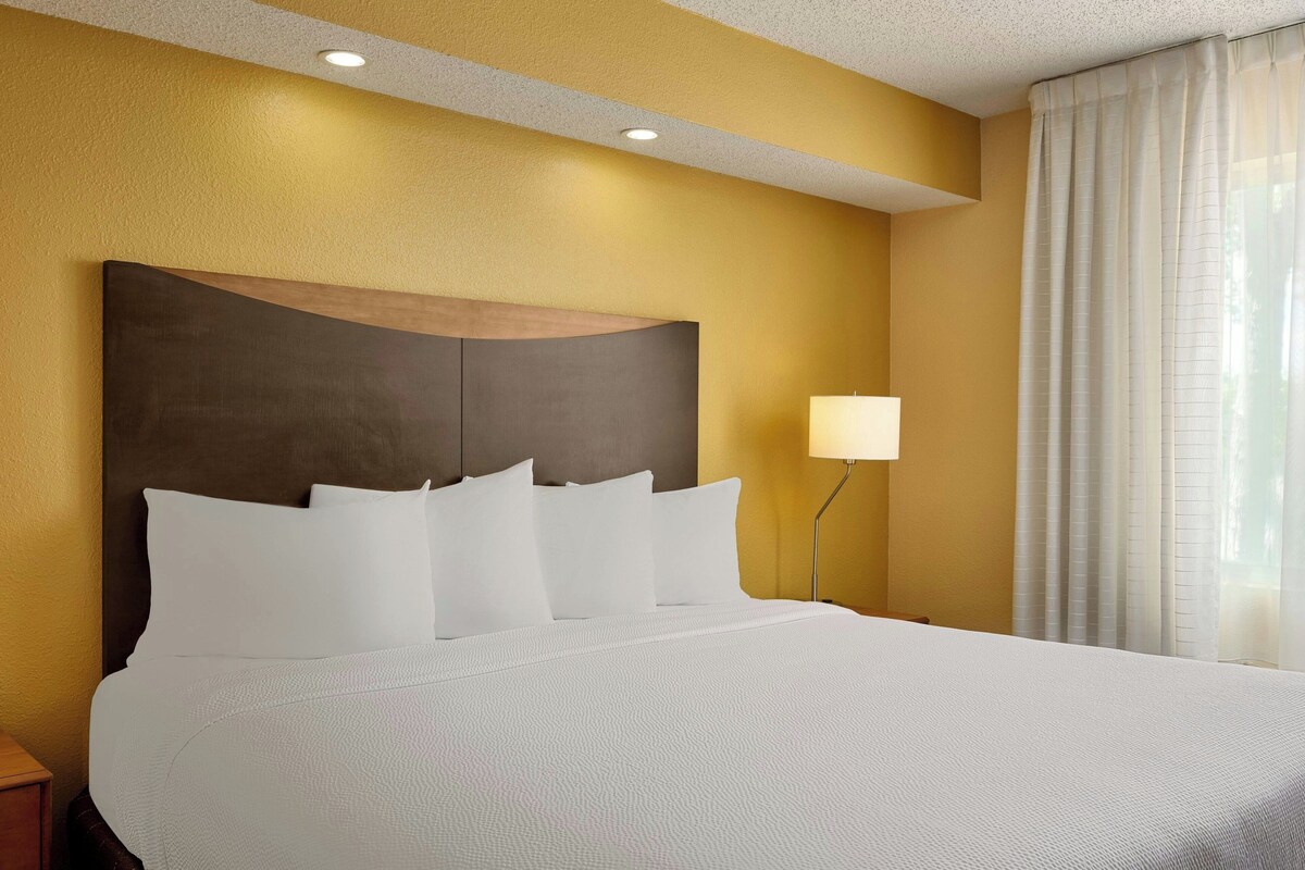 Premium bedding, desk, laptop workspace, blackout curtains