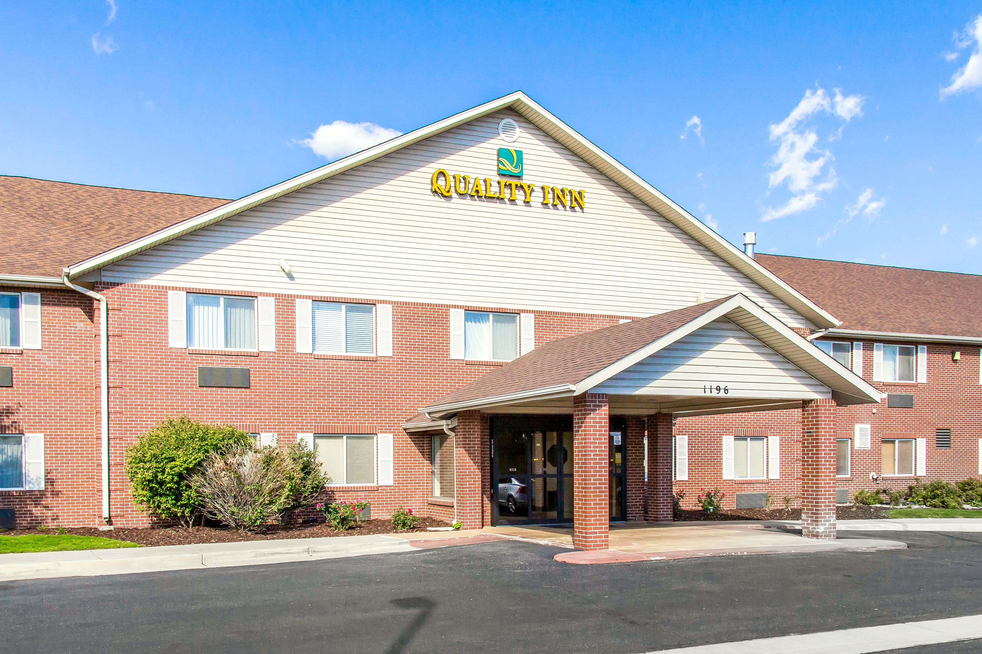 A brick building with a sign reading "Quality Inn."