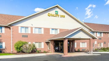 A brick building with a sign reading "Quality Inn."