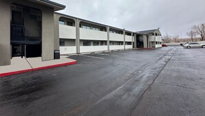 A multi-story parking garage with a covered walkway and a building adjacent to it.