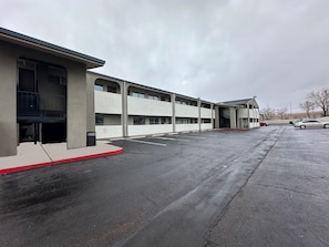 A multi-story parking garage with a covered walkway and a building adjacent to it.