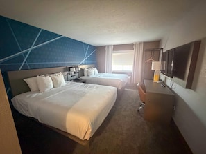 A hotel room with two beds, a desk, a TV, and a window with curtains. - Comfort Suites Albuquerque/North Journal Center (Albuquerque)