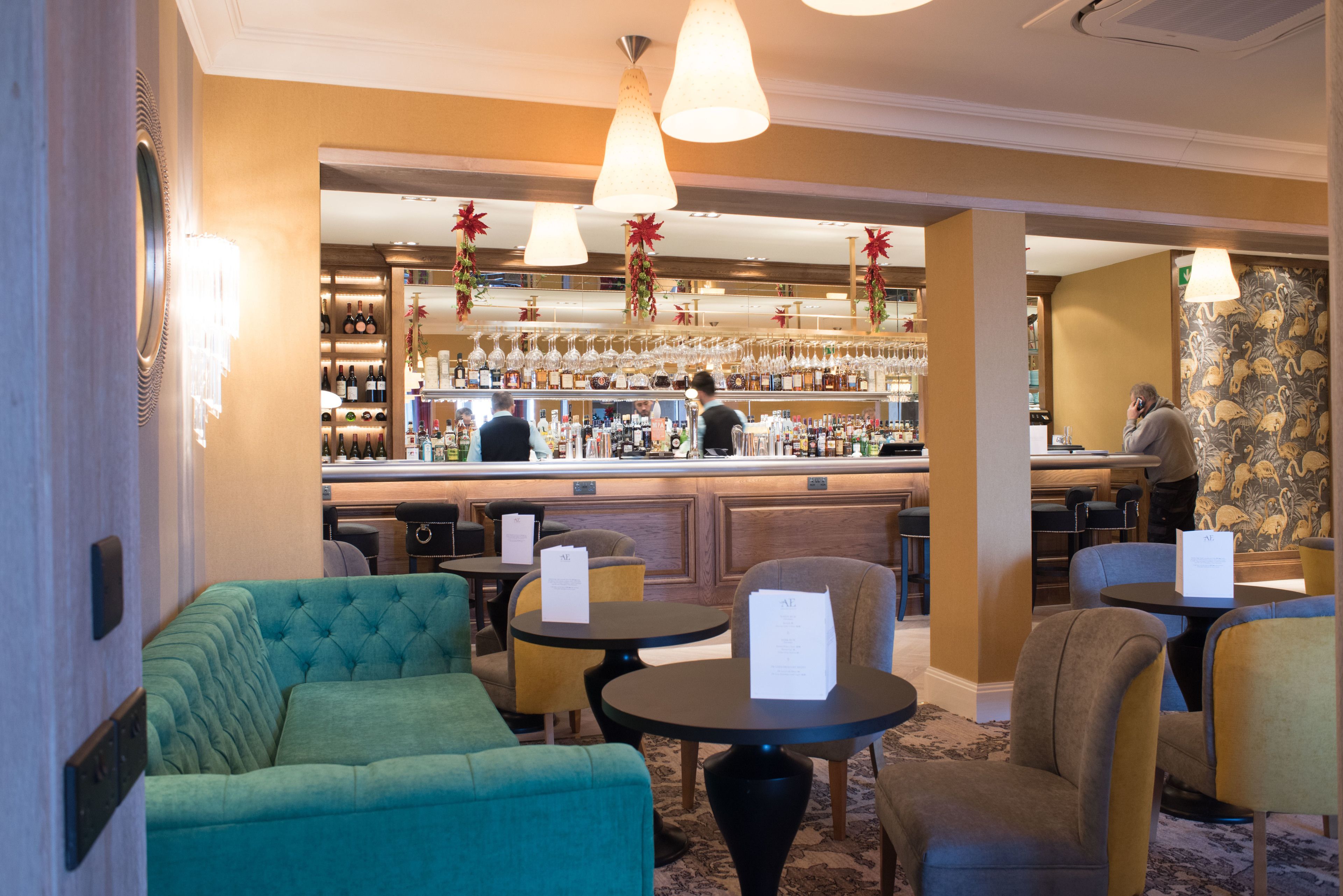 A bar area with seating and a wine display.