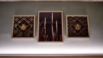 Three framed artworks on a wall.