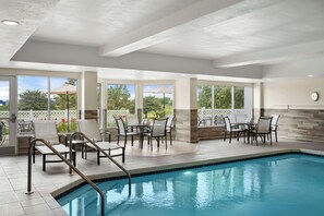 A pool area with a clear view of the outdoors, including trees and a fence. - Fairfield Inn & Suites by Marriott Madison West/Middleton (Middleton)