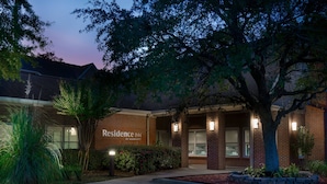 A brick building with the sign "Residence Inn by Marriott" at dusk.