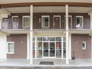Stunning two-story building with a large glass entrance and balcony.