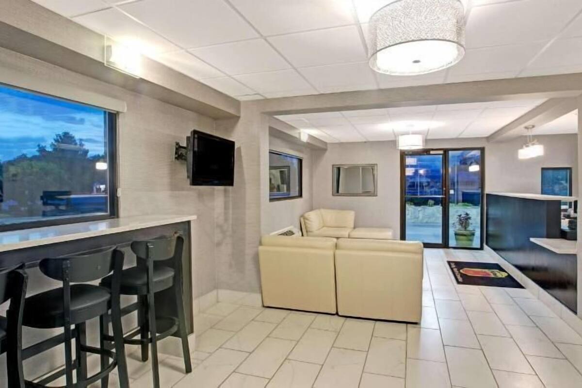 A modern interior with a bar area, seating, and a large window.