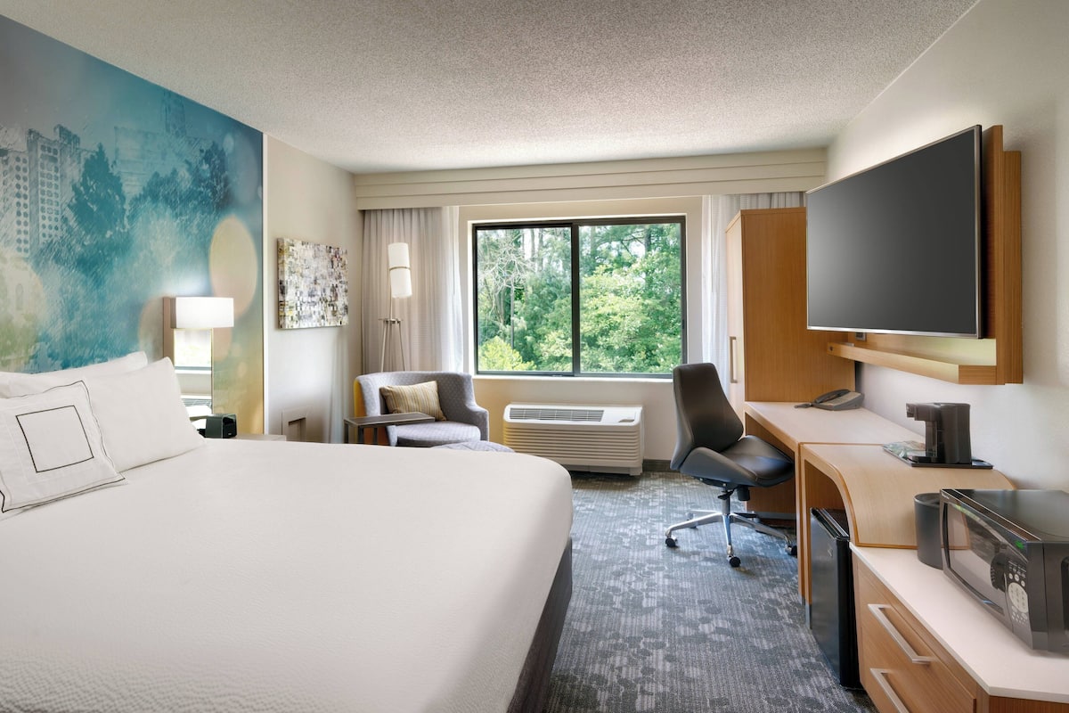 Hypo-allergenic bedding, desk, laptop workspace, blackout drapes