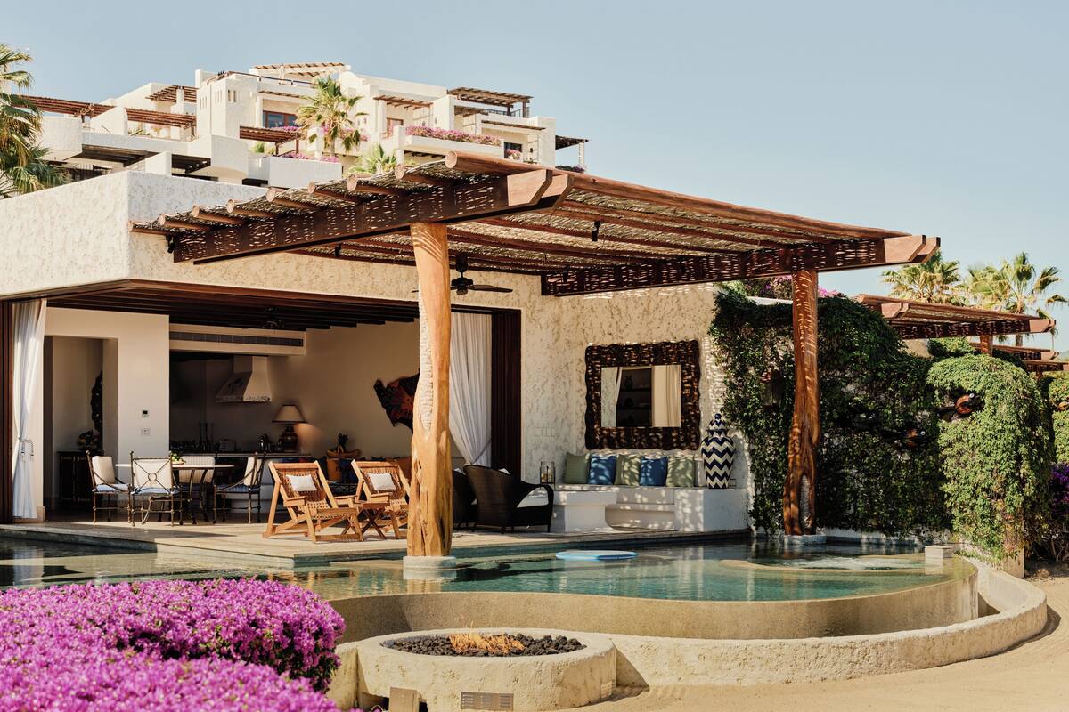 A resort with a pool, outdoor seating, and a covered patio area.