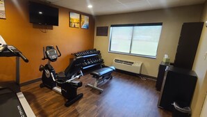 A gym with treadmills, an elliptical, and a weight bench. - Comfort Inn & Suites Leeds I-20 (Leeds)