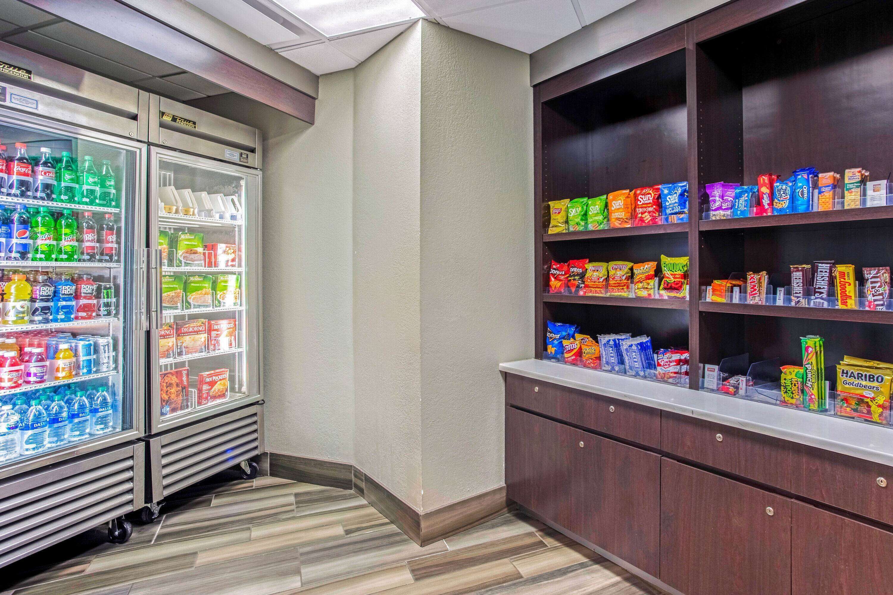 A vending area with refrigerated drinks and snack options.