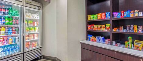 A vending area with refrigerated drinks and snack options.