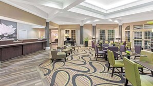 A spacious lobby with a reception desk, seating area, and large windows. - La Quinta Inn & Suites by Wyndham Birmingham Homewood (Birmingham)
