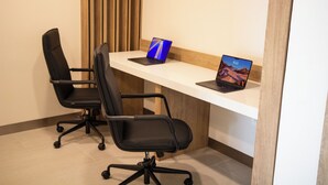 A workspace with two black office chairs, a white desk, and two laptops. - Holiday Inn Express Torreon by IHG (Torreón)