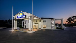A Days Inn hotel entrance with a clear sign, a covered parking area, and a well-lit facade. - Days Inn by Wyndham Enterprise (Enterprise)