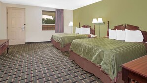 A hotel room with two beds, a window with a view, a door, and a patterned carpet. - Days Inn by Wyndham Eufaula AL (Eufaula)
