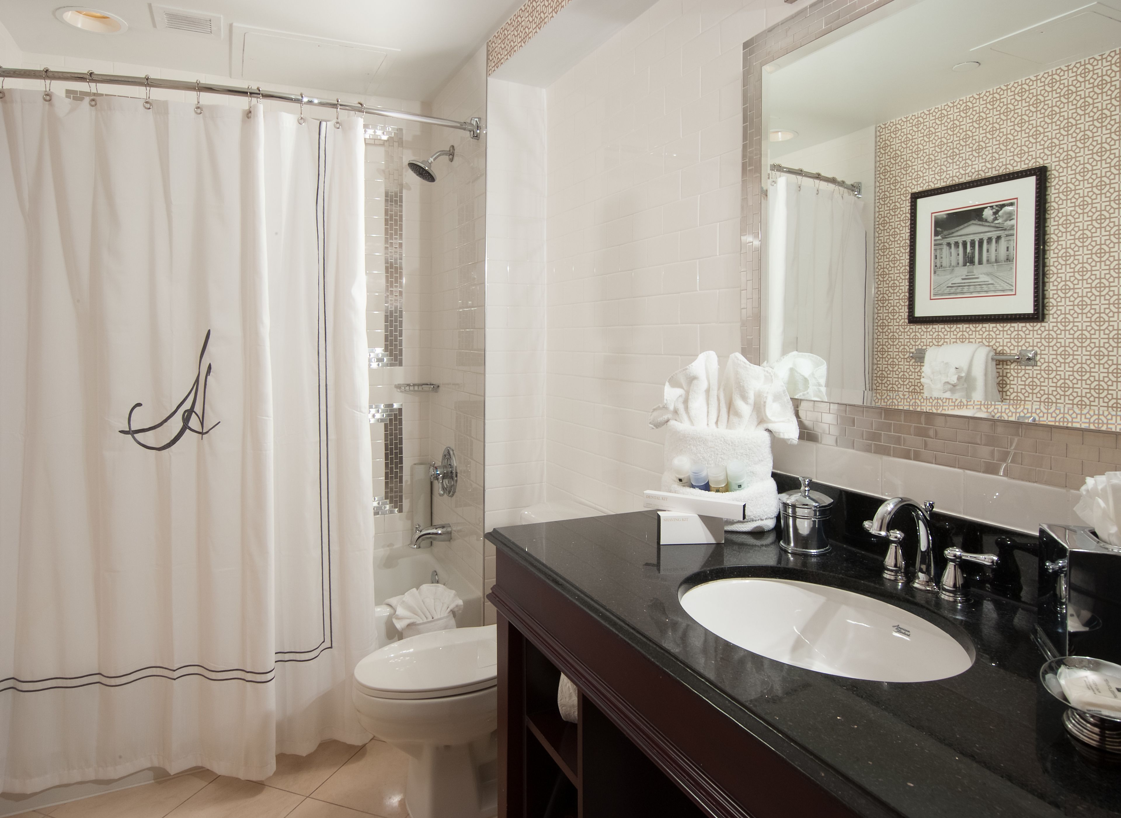 A modern bathroom with a shower, toilet, and vanity.