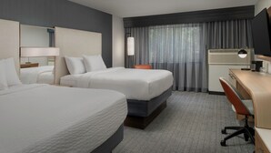 A hotel room with two beds, a desk, a chair, a TV, and a window with curtains. - Courtyard by Marriott Dothan (Dothan)