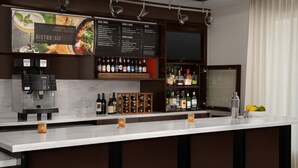 A bar area with a menu board, a coffee machine, and a wine cooler. - Courtyard by Marriott Dothan (Dothan)