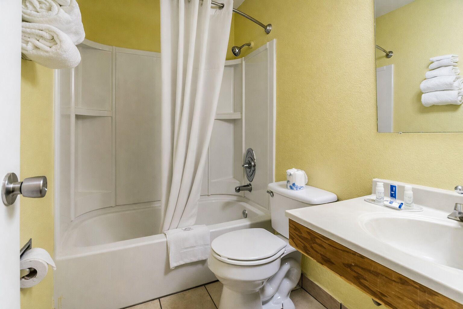 A bathroom with a bathtub, toilet, and sink.