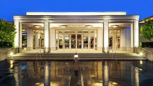The exterior of the Richard Nixon Presidential Library and Museum with a reflective pool in front.