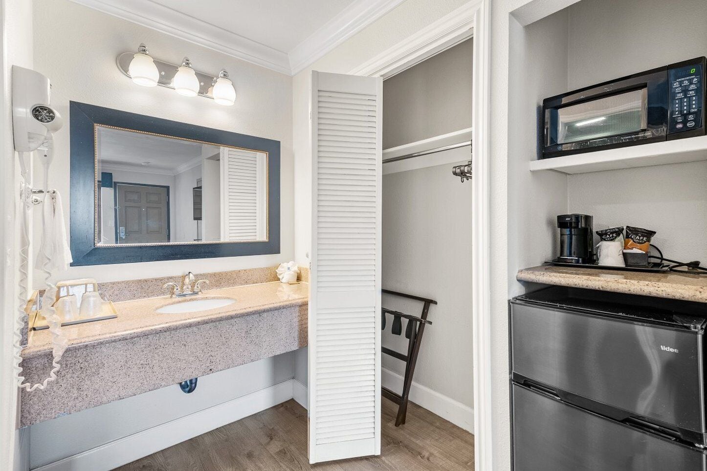 A modern bathroom with a vanity, sink, and mirror.