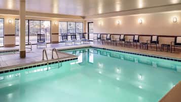 Relax by the pool surrounded by comfortable seating and large windows offering views of the surrounding area.