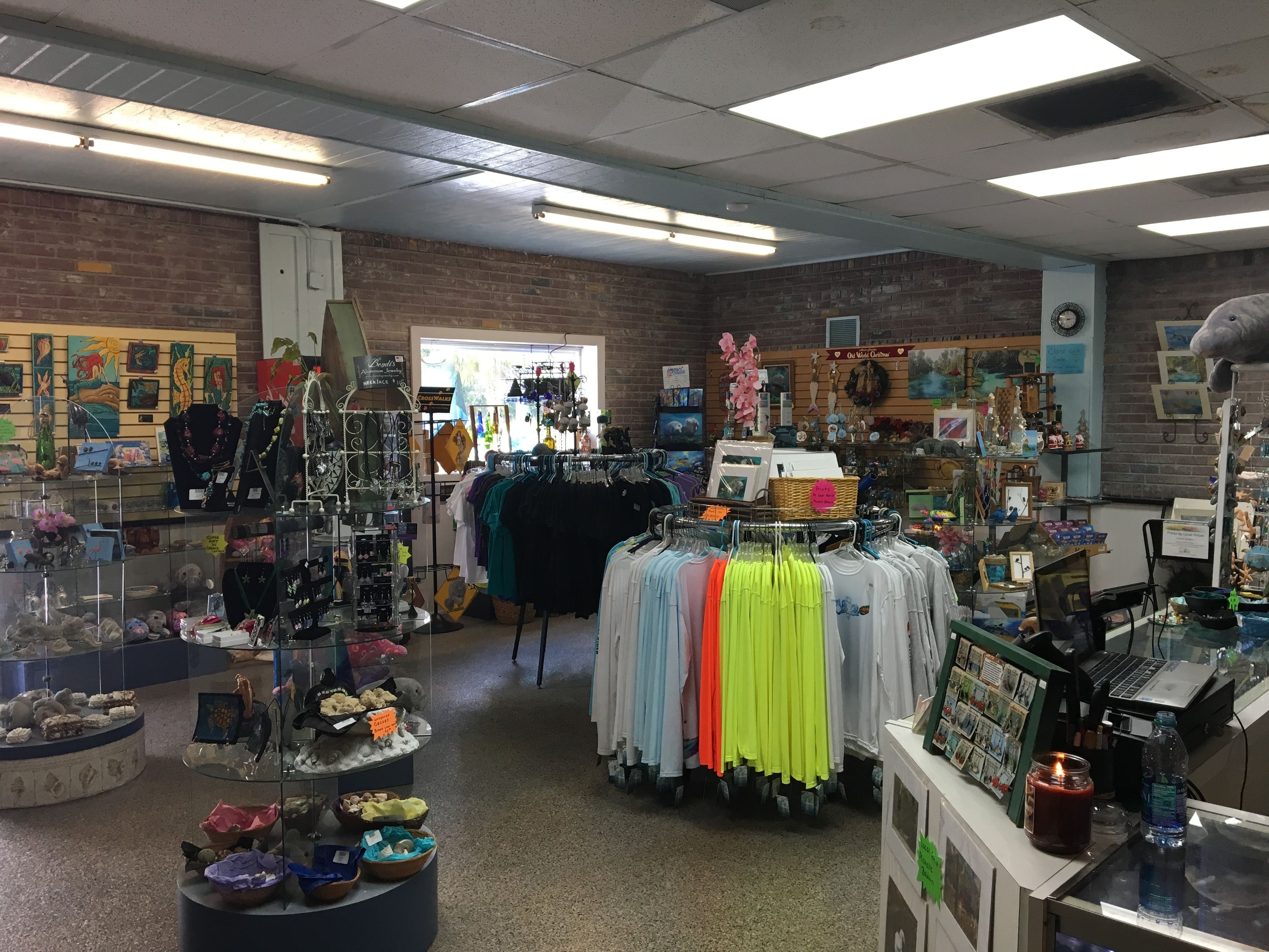 A retail store with various items on display, including clothing racks, jewelry, and decorative items.