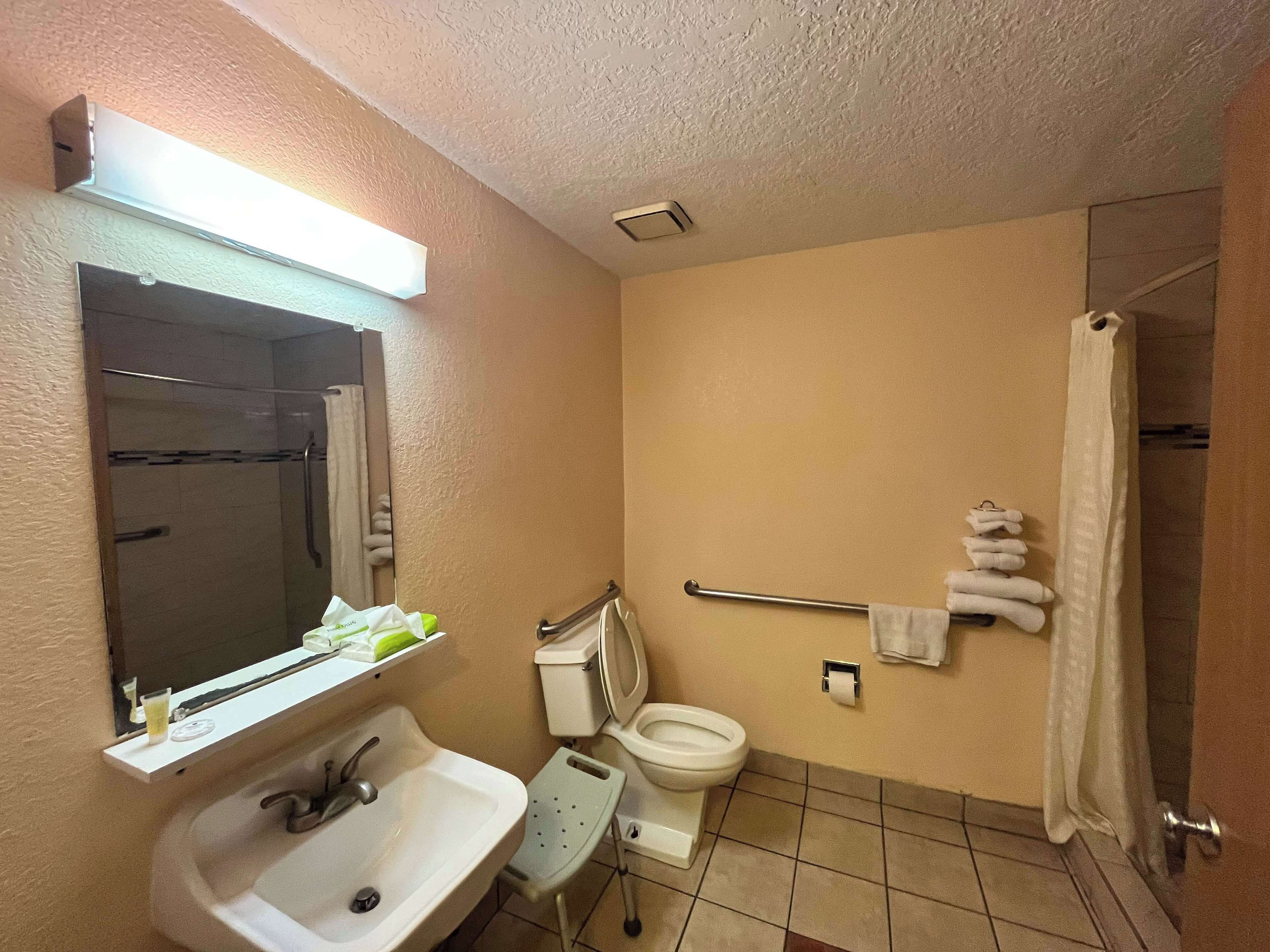 A bathroom with a sink, toilet, and shower.