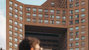 A JW Marriott hotel with a distinctive curved facade and multiple floors.