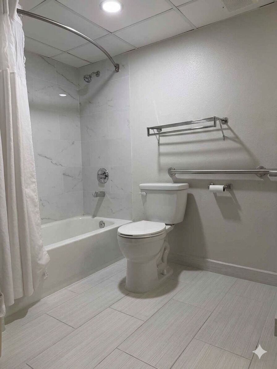 A bathroom with a bathtub, toilet, and shower.