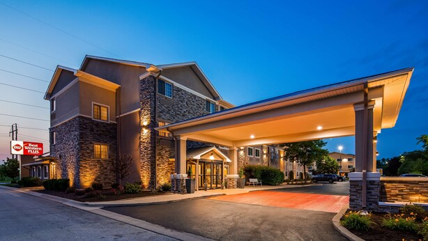 A hotel with a stone facade, a covered entrance, and a Best Western Plus sign.
