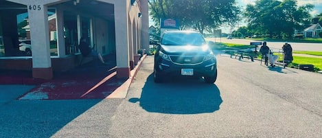 A car parked in front of a building with a sign that reads 'CENTER'.