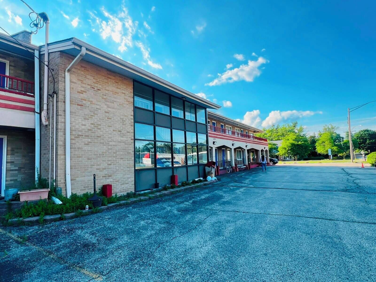 A building with a brick facade, large windows, and a flat roof.